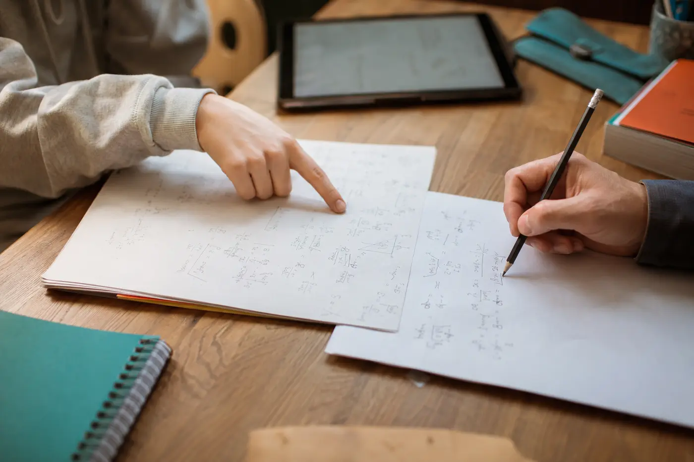 A learner and educator working through a paper assignment and a separate explanation